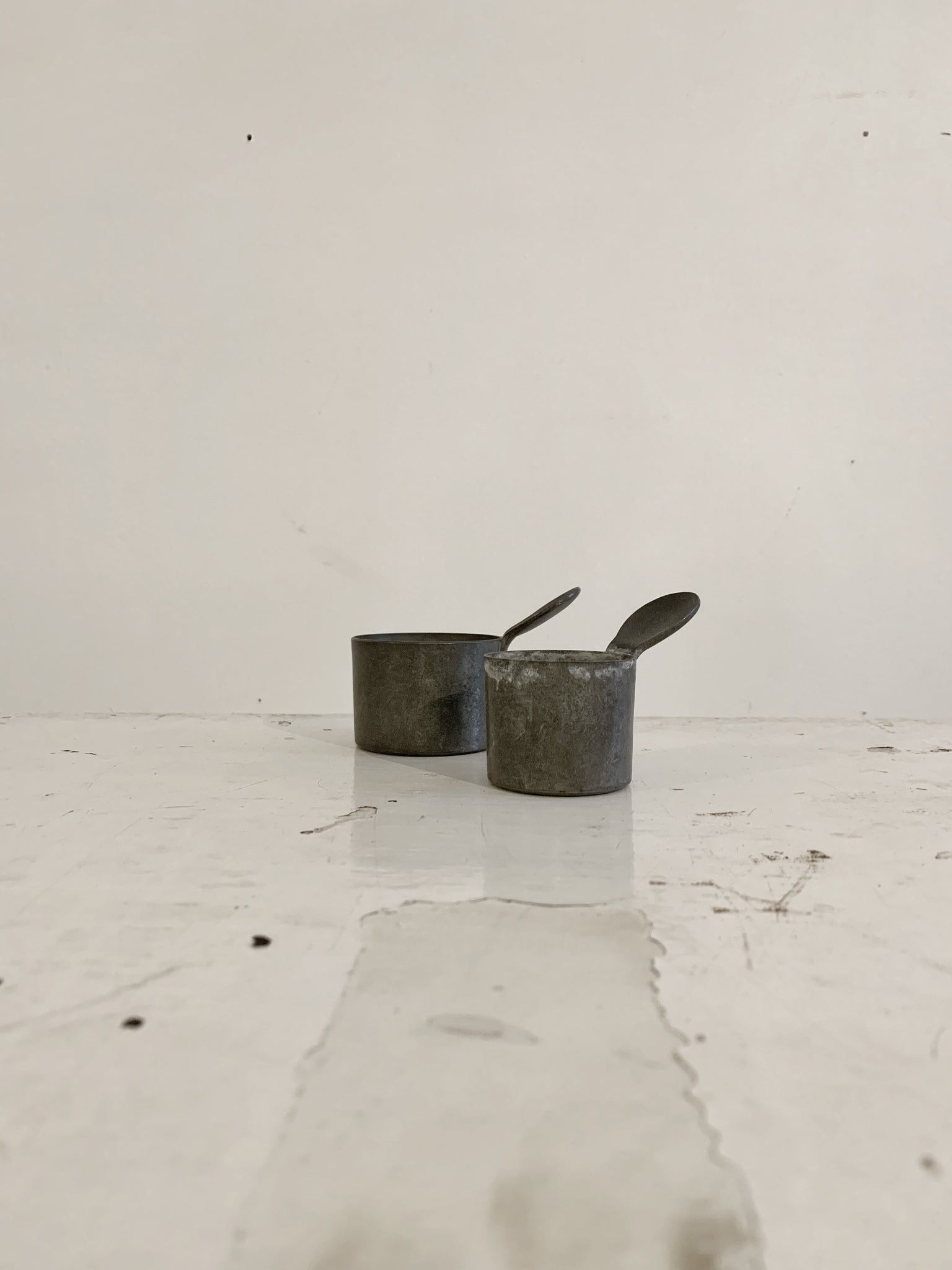 Pair antique apothecary metal measuring cups