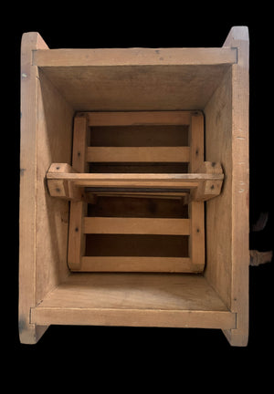 Interior view of antique butter churn showing wooden paddles
