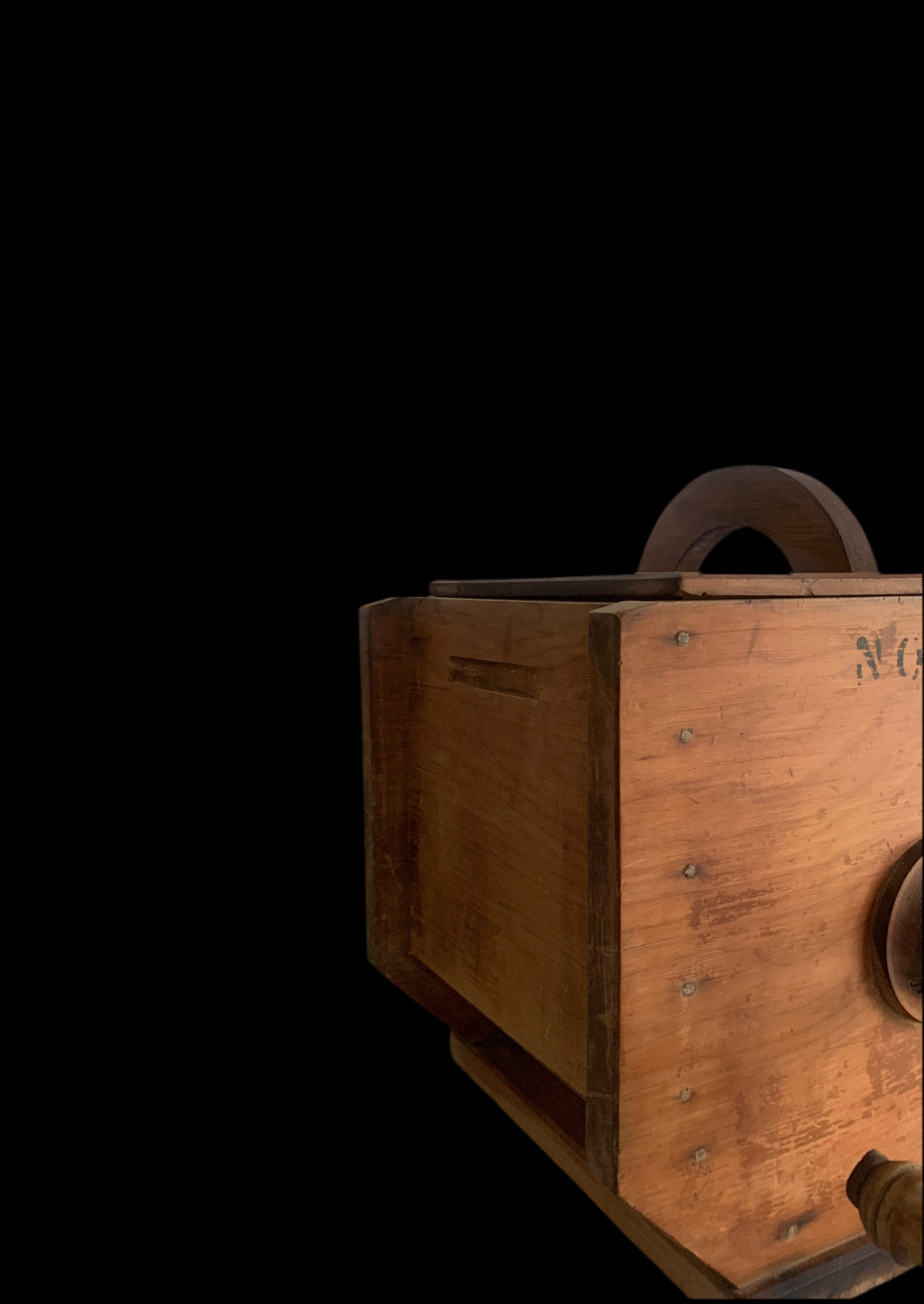 Side profile of antique wooden box butter churn showing aged timber
